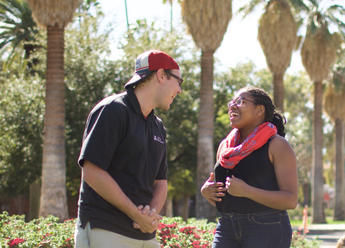 Two students with clasped hands talking